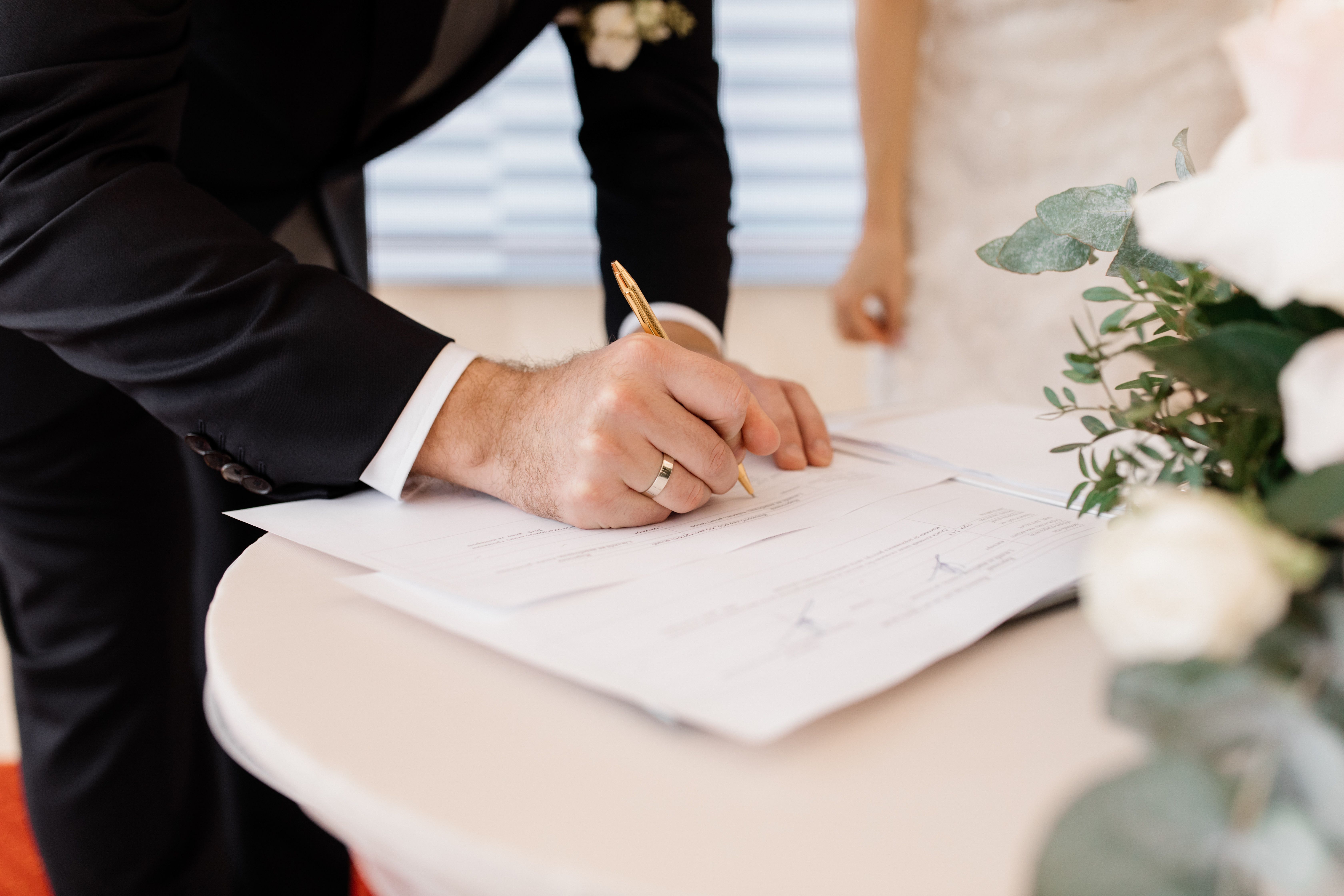 couple-love-is-signing-official-marriage-documents.jpg