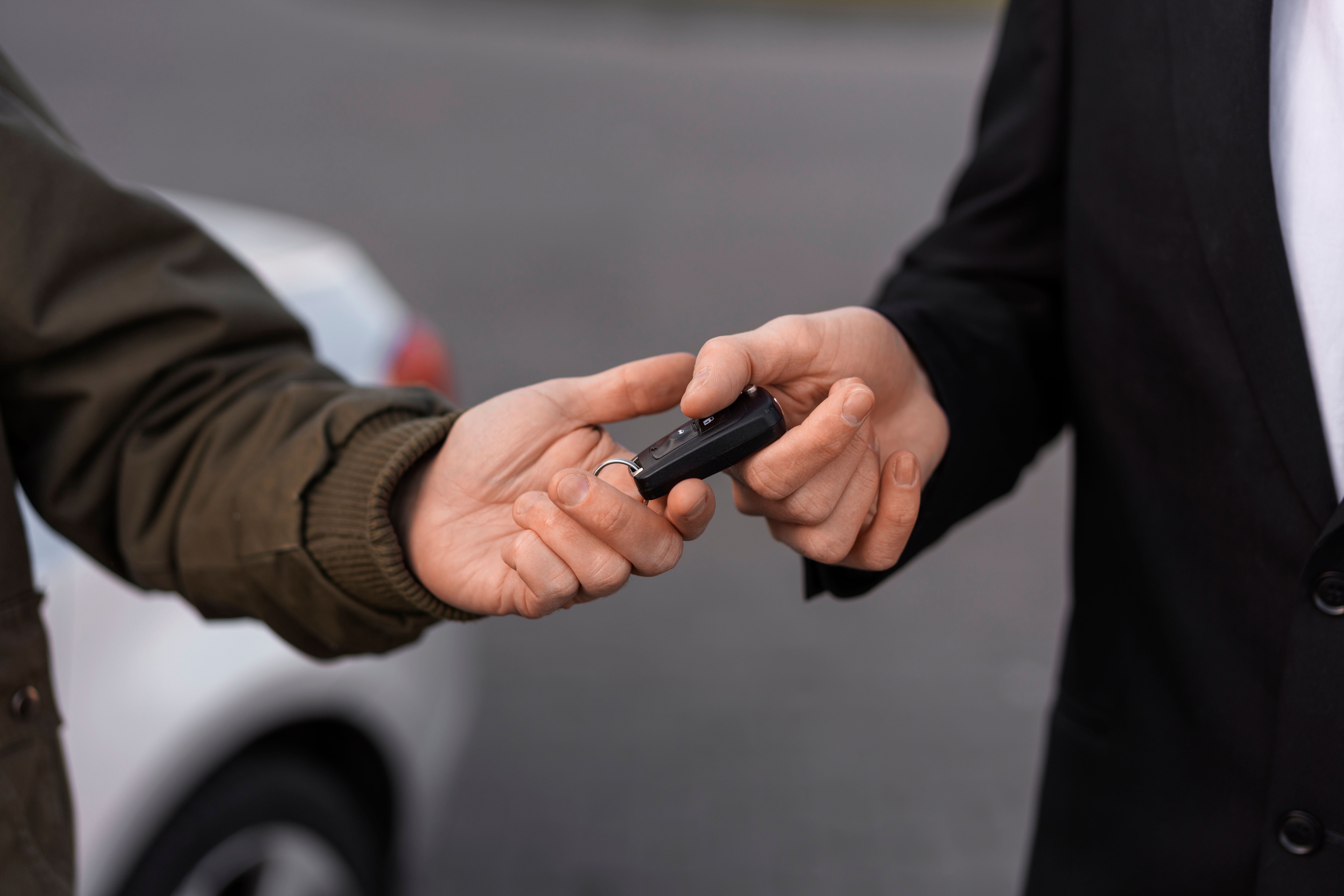 high-angle-hands-holding-car-key.jpg